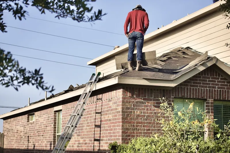 Professional roofer working on a residential roof in Sergeantsville